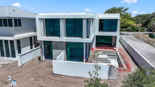 305 Grove Pl, Delray Beach, FL 33444 - rear view of property featuring stucco siding