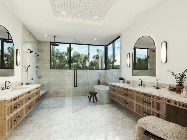 305 Grove Pl, Delray Beach, FL 33444 - bathroom featuring a shower stall, marble look tiles, recessed lighting, two vanities, and a soaking tub