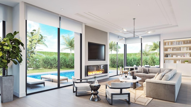 305 Grove Pl, Delray Beach, FL 33444 - living area featuring wood finished floors, floor to ceiling windows, a tray ceiling, a glass covered fireplace, and recessed lighting