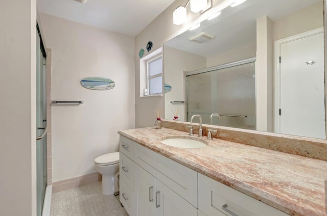 bathroom with vanity, toilet, baseboards, tile patterned floors, and a shower stall