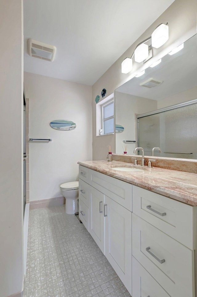 full bath featuring visible vents, vanity, toilet, baseboards, and a stall shower