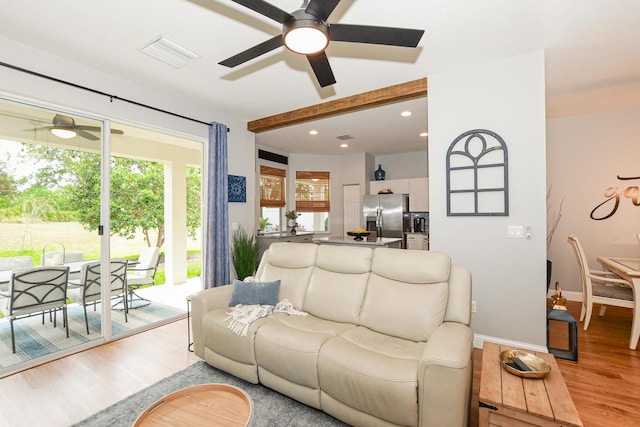 living area with ceiling fan, light wood finished floors, recessed lighting, baseboards, and visible vents