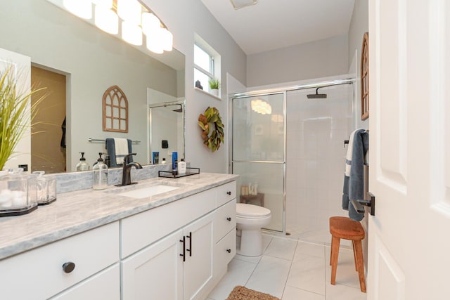 bathroom with toilet, a shower stall, and vanity