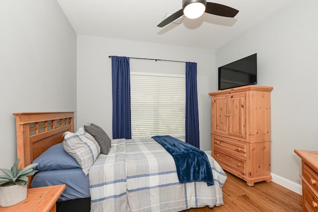 bedroom featuring baseboards, ceiling fan, and light wood finished floors
