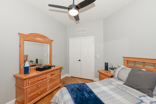bedroom featuring baseboards, a closet, light wood-style flooring, and visible vents