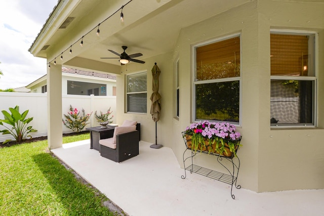 view of patio / terrace with fence and a ceiling fan