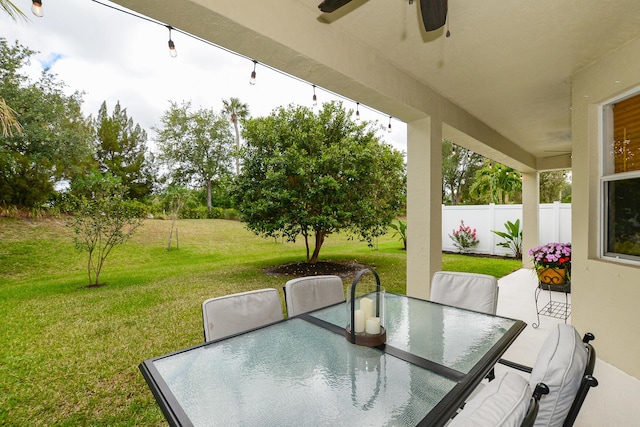 view of patio / terrace with fence, outdoor dining area, and ceiling fan