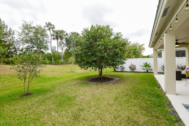 view of yard featuring fence and a patio