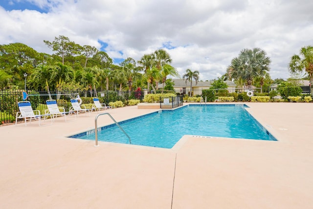 pool with fence and a patio