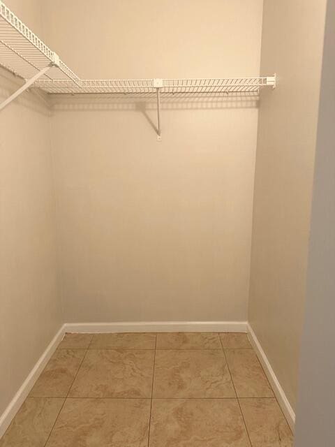 spacious closet featuring light tile patterned floors