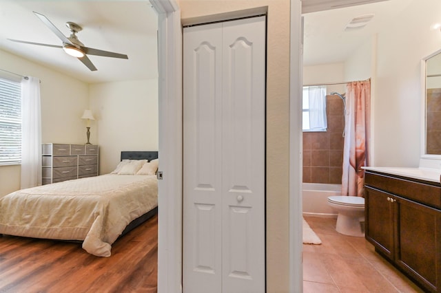 7384 NW Greenspring St, Port Saint Lucie, FL 34987 - bedroom with light wood finished floors, connected bathroom, a closet, and a ceiling fan