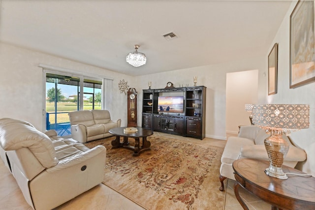 7384 NW Greenspring St, Port Saint Lucie, FL 34987 - living area with light tile patterned floors and a chandelier