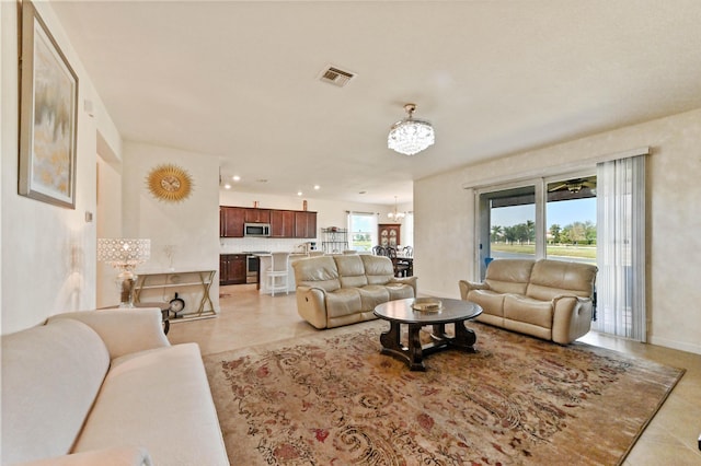 7384 NW Greenspring St, Port Saint Lucie, FL 34987 - living room featuring a chandelier, light tile patterned flooring, baseboards, and recessed lighting