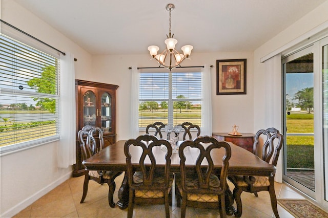 7384 NW Greenspring St, Port Saint Lucie, FL 34987 - dining area featuring a chandelier, light tile patterned floors, healthy amount of natural light, and baseboards