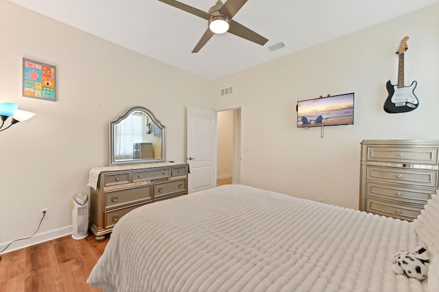 7384 NW Greenspring St, Port Saint Lucie, FL 34987 - bedroom with wood finished floors, baseboards, and a ceiling fan
