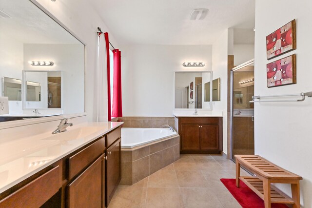 7384 NW Greenspring St, Port Saint Lucie, FL 34987 - bathroom with a stall shower, tile patterned floors, a bath, and two vanities