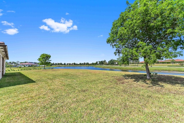 7384 NW Greenspring St, Port Saint Lucie, FL 34987 - view of grassy yard with a water view