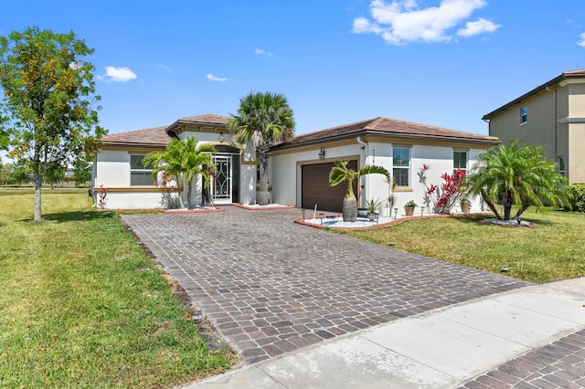 7384 NW Greenspring St, Port Saint Lucie, FL 34987 - mediterranean / spanish home featuring stucco siding, an attached garage, decorative driveway, and a front yard