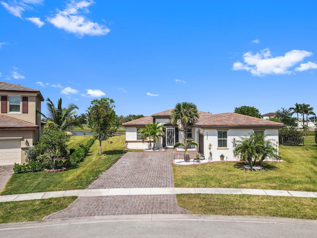 7384 NW Greenspring St, Port Saint Lucie, FL 34987 - mediterranean / spanish-style house featuring driveway, a front yard, and stucco siding