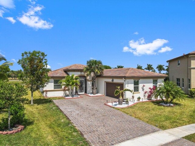 7384 NW Greenspring St, Port Saint Lucie, FL 34987 - mediterranean / spanish-style house featuring stucco siding, an attached garage, driveway, a tiled roof, and a front lawn