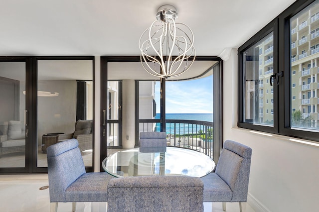 5380 N Ocean Dr Unit 5A, Riviera Beach, FL 33404 - dining area with light tile patterned floors, ornamental molding, a chandelier, and visible vents