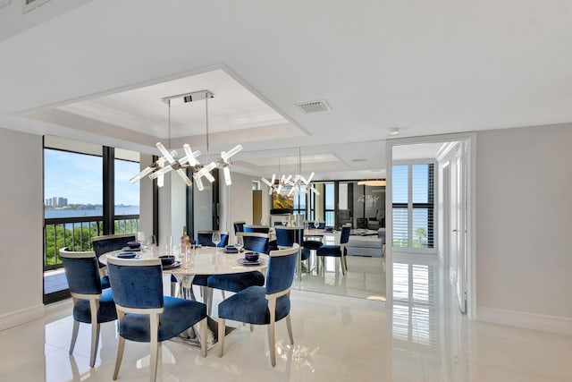 5380 N Ocean Dr Unit 5A, Riviera Beach, FL 33404 - dining area with a tray ceiling, an inviting chandelier, baseboards, and visible vents
