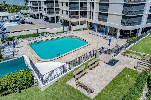 5380 N Ocean Dr Unit 5A, Riviera Beach, FL 33404 - view of swimming pool featuring fence, a patio, and a community hot tub
