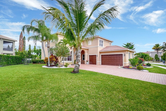 8841 Cobblestone Point Cir, Boynton Beach, FL 33472 - mediterranean / spanish-style home featuring an attached garage, a tile roof, stucco siding, a front yard, and driveway