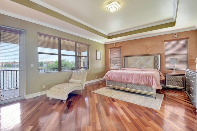 8841 Cobblestone Point Cir, Boynton Beach, FL 33472 - bedroom featuring access to outside, baseboards, wood-type flooring, ornamental molding, and a tray ceiling