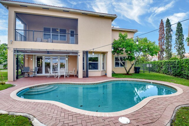 8841 Cobblestone Point Cir, Boynton Beach, FL 33472 - back of property with fence, stucco siding, and a patio area