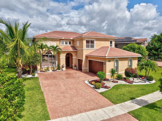 8841 Cobblestone Point Cir, Boynton Beach, FL 33472 - mediterranean / spanish home featuring a tile roof, a garage, stucco siding, a front yard, and decorative driveway