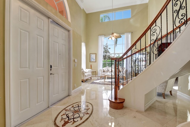 8841 Cobblestone Point Cir, Boynton Beach, FL 33472 - foyer featuring a towering ceiling, crown molding, baseboards, marble finish floor, and stairs