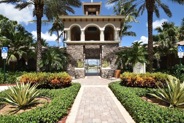8841 Cobblestone Point Cir, Boynton Beach, FL 33472 - exterior space with a gate, stucco siding, and stone siding