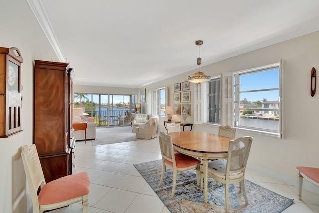 1910 S Ocean Blvd Unit 338, Delray Beach, FL 33483 - dining space with light tile patterned floors, a water view, and ornamental molding