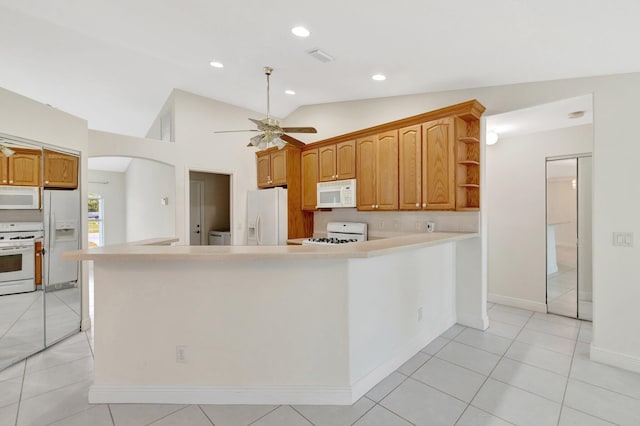 189 SE Floresta Dr, Port Saint Lucie, FL 34983 - kitchen with white appliances, ceiling fan, light countertops, vaulted ceiling, and recessed lighting