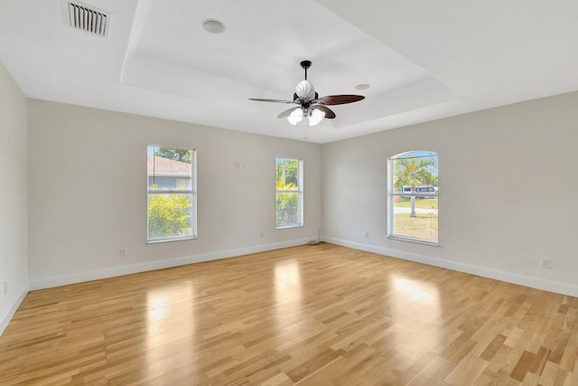 189 SE Floresta Dr, Port Saint Lucie, FL 34983 - spare room featuring a raised ceiling, ceiling fan, light wood-style flooring, and baseboards