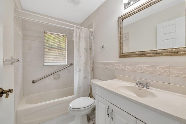 189 SE Floresta Dr, Port Saint Lucie, FL 34983 - bathroom with tile walls, toilet, vanity, shower / tub combo with curtain, and a wainscoted wall