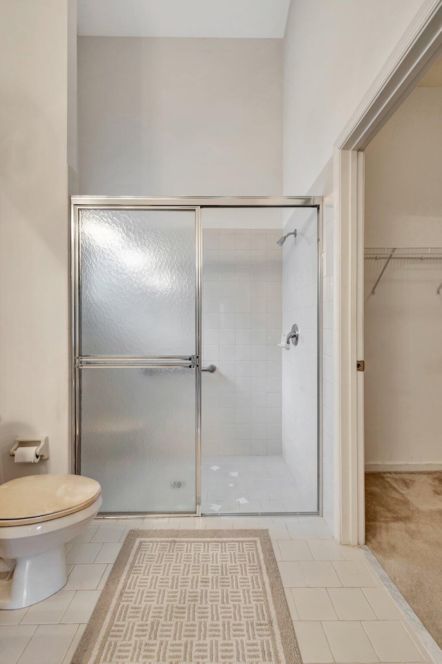 13006 Hampton Lakes Cir, Boynton Beach, FL 33436 - full bathroom featuring toilet, a shower stall, a spacious closet, and tile patterned flooring