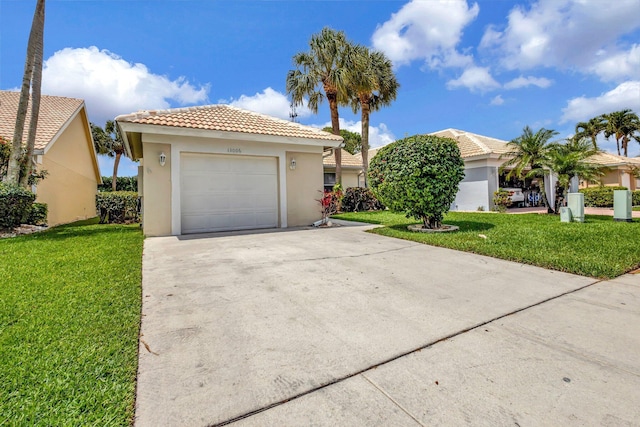 13006 Hampton Lakes Cir, Boynton Beach, FL 33436 - view of front of house featuring driveway, stucco siding, a tile roof, and a front lawn