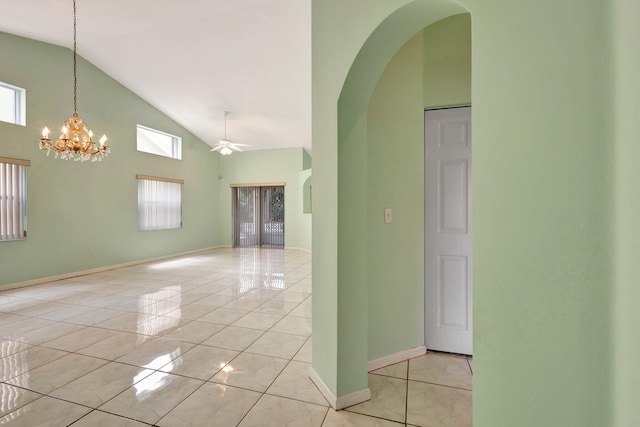 13006 Hampton Lakes Cir, Boynton Beach, FL 33436 - unfurnished room with high vaulted ceiling, arched walkways, ceiling fan, a chandelier, and baseboards
