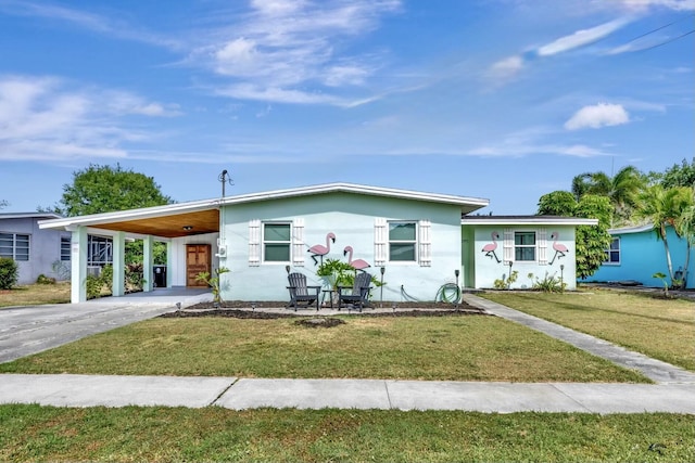 2971 SE Morningside Blvd, Port Saint Lucie, FL 34952 - view of front of house with stucco siding, driveway, a front yard, and a carport