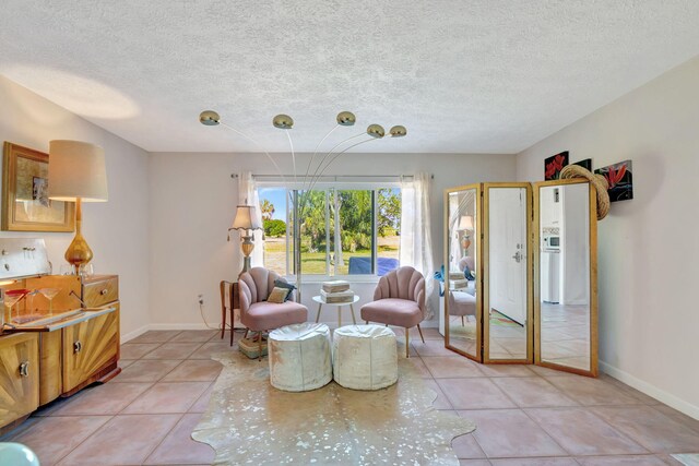 2971 SE Morningside Blvd, Port Saint Lucie, FL 34952 - living area featuring baseboards, a textured ceiling, and light tile patterned floors