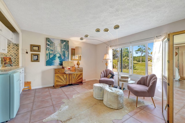 2971 SE Morningside Blvd, Port Saint Lucie, FL 34952 - sitting room featuring light tile patterned floors, baseboards, and a textured ceiling