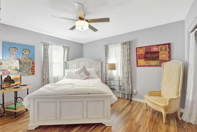 2971 SE Morningside Blvd, Port Saint Lucie, FL 34952 - bedroom featuring baseboards, ceiling fan, and light wood finished floors