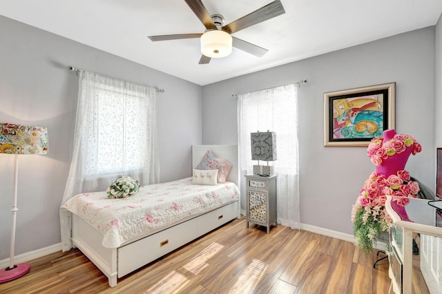 2971 SE Morningside Blvd, Port Saint Lucie, FL 34952 - bedroom featuring baseboards, a ceiling fan, and wood finished floors