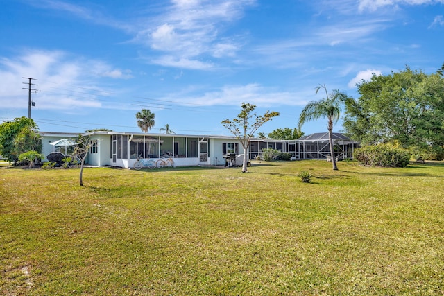 2971 SE Morningside Blvd, Port Saint Lucie, FL 34952 - back of property with a lawn and a sunroom