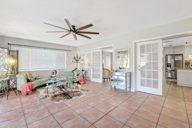 2971 SE Morningside Blvd, Port Saint Lucie, FL 34952 - living area with french doors, a textured ceiling, ceiling fan, and light tile patterned floors