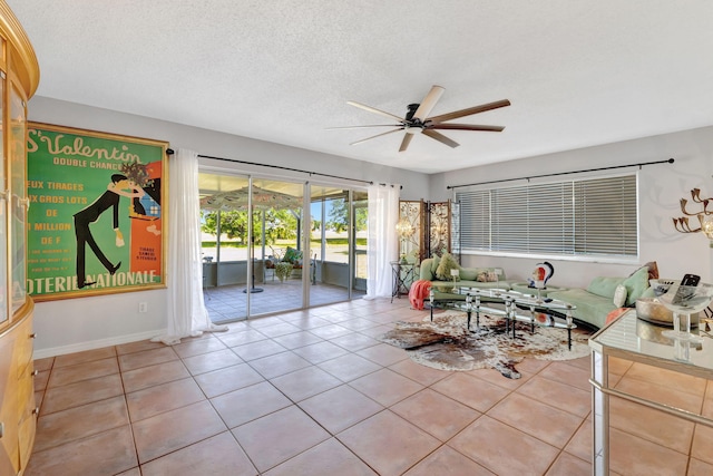 2971 SE Morningside Blvd, Port Saint Lucie, FL 34952 - living area with baseboards, a textured ceiling, ceiling fan, and light tile patterned floors