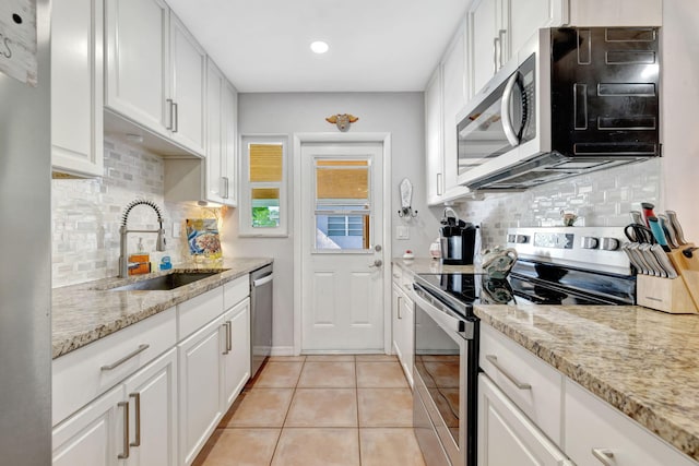 2971 SE Morningside Blvd, Port Saint Lucie, FL 34952 - kitchen featuring a sink, tasteful backsplash, stainless steel appliances, and white cabinets