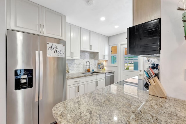 2971 SE Morningside Blvd, Port Saint Lucie, FL 34952 - kitchen featuring a sink, decorative backsplash, white cabinets, and stainless steel appliances